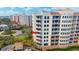 Mediterranean-style condo building featuring multiple balconies with great views, tile roof and manicured landscaping at 261 Minorca Beach Way # 406, New Smyrna Beach, FL 32169