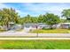 Charming single-story home featuring a well-manicured front yard and a welcoming red front door at 2809 Lime Tree Dr, Edgewater, FL 32141