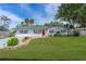 Charming home with well-manicured lawn, stone accents, and a vibrant red front door at 2809 Lime Tree Dr, Edgewater, FL 32141