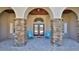 Inviting front porch with stone columns and seating area for relaxing at 2904 Palma Ln, New Smyrna Beach, FL 32168