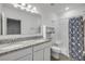 Bathroom with granite counters, dual sinks, and a separate shower tub at 2921 India Palm Dr, Edgewater, FL 32141