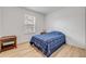 Bright bedroom features wood-look flooring and a window with natural light at 2921 India Palm Dr, Edgewater, FL 32141