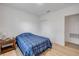 Bedroom with wood-look flooring, white walls, and a closet for storage at 2921 India Palm Dr, Edgewater, FL 32141