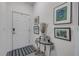 Welcoming entryway with a decorative table, artwork, and a stylish striped rug at 2921 India Palm Dr, Edgewater, FL 32141
