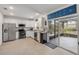 Bright kitchen featuring stainless steel appliances and granite countertops, with a sliding glass door to a screened patio at 2921 India Palm Dr, Edgewater, FL 32141