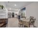 Bright kitchen with white cabinets, stainless steel appliances, and a dining table at 2921 India Palm Dr, Edgewater, FL 32141