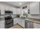 Bright kitchen with stainless steel appliances, granite countertops and ample storage in white cabinetry at 2921 India Palm Dr, Edgewater, FL 32141