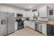 Well-lit kitchen featuring white cabinets, stainless steel appliances, and granite countertops for a modern look and feel at 2921 India Palm Dr, Edgewater, FL 32141