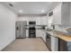 Modern kitchen with white cabinets, granite countertops, stainless steel appliances, and tile floors for easy maintenance at 2921 India Palm Dr, Edgewater, FL 32141