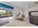 Open-concept living area with a view of the screened patio, neutral tile, and natural light at 2921 India Palm Dr, Edgewater, FL 32141
