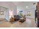 Cozy living room featuring neutral tile flooring, a leather sofa, and ample natural light at 2921 India Palm Dr, Edgewater, FL 32141