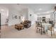 Open-concept living area with a leather sofa, dining table, and access to the kitchen at 2921 India Palm Dr, Edgewater, FL 32141