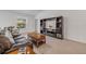 Comfortable living room showcasing a stylish entertainment center, seating, and a bright window at 2921 India Palm Dr, Edgewater, FL 32141