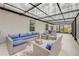 A cozy outdoor patio features a stylish wicker seating area with blue cushions, inviting relaxation and gatherings at 2921 India Palm Dr, Edgewater, FL 32141