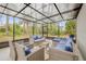 Enclosed patio with wicker furniture provides a comfortable outdoor lounge area at 2921 India Palm Dr, Edgewater, FL 32141