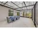 Enclosed patio offers a spacious area with a dining table and access to the backyard at 2921 India Palm Dr, Edgewater, FL 32141