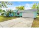 Charming home featuring a spacious driveway, two-car garage and turquoise exterior paint at 3 Castle Manor Dr, Ormond Beach, FL 32174