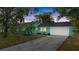 Brightly colored home with lush landscaping, driveway, and a two-car garage at 3 Castle Manor Dr, Ormond Beach, FL 32174