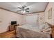 Cozy bedroom with wood floors, ceiling fan, and floral wallpaper border at 3522 Forest Branch Dr # B, Port Orange, FL 32129