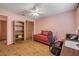 Bedroom featuring wood floors, a ceiling fan, a bookshelf, and closet at 3522 Forest Branch Dr # B, Port Orange, FL 32129