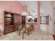 A dining room with tile flooring, a glass table, and seamless view into the kitchen at 3522 Forest Branch Dr # B, Port Orange, FL 32129