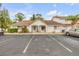 Exterior shot of the condo, with vibrant foliage, parking, and tile roofing at 3522 Forest Branch Dr # B, Port Orange, FL 32129