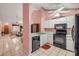 The kitchen features stainless steel sink, white cabinets, and black appliances at 3522 Forest Branch Dr # B, Port Orange, FL 32129