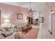 An open concept living room features a ceiling fan, large rug, and tile floors at 3522 Forest Branch Dr # B, Port Orange, FL 32129