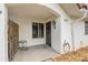 A cozy tiled front porch featuring a small table, privacy fence and stylish security door at 3522 Forest Branch Dr # B, Port Orange, FL 32129