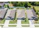 Aerial view of a well-maintained home showcasing landscaping, driveway, and proximity to neighboring houses at 532 White Coral Ln, New Smyrna Beach, FL 32168