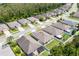 Aerial view of a charming home highlighting its landscaping, driveway, and nearby community at 532 White Coral Ln, New Smyrna Beach, FL 32168