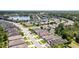 Aerial view of a well-maintained home in a neighborhood with trees and a lake in the distance at 532 White Coral Ln, New Smyrna Beach, FL 32168