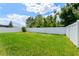 Spacious backyard featuring a privacy fence and green lawn, perfect for outdoor activities at 532 White Coral Ln, New Smyrna Beach, FL 32168