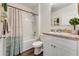 Bathroom with a shower-tub combo and a white vanity with decorative elements at 532 White Coral Ln, New Smyrna Beach, FL 32168