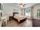 Inviting bedroom with a cozy bed, wood-look flooring, and natural light, creating a relaxing atmosphere at 532 White Coral Ln, New Smyrna Beach, FL 32168