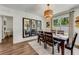 Cozy dining room with a wooden table, chairs, and modern light fixture at 532 White Coral Ln, New Smyrna Beach, FL 32168