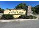 Sabal Lakes community sign on a sunny day with manicured landscaping at 532 White Coral Ln, New Smyrna Beach, FL 32168