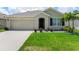 Charming home with a two-car garage, well-manicured lawn, and lovely landscaping at 532 White Coral Ln, New Smyrna Beach, FL 32168