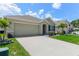 Charming home with a two-car garage, well-manicured lawn, and lovely landscaping at 532 White Coral Ln, New Smyrna Beach, FL 32168