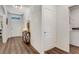 Bright foyer with wood flooring, white walls, and modern light fixture at 532 White Coral Ln, New Smyrna Beach, FL 32168