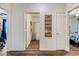 Hallway with wood-look floors, sign, and doors to a bathroom and bedroom at 532 White Coral Ln, New Smyrna Beach, FL 32168