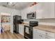 White cabinets and black appliances create a great kitchen design at 532 White Coral Ln, New Smyrna Beach, FL 32168