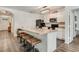 Open kitchen with stainless steel appliances, white cabinets, and a breakfast bar at 532 White Coral Ln, New Smyrna Beach, FL 32168