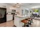 Open kitchen with stainless steel appliances, white cabinets, and a breakfast bar at 532 White Coral Ln, New Smyrna Beach, FL 32168