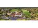 Aerial view of a golf community clubhouse with beautifully maintained course and landscaping at 56 Live Oak Ln, New Smyrna Beach, FL 32168