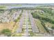 An aerial view shows a quiet neighborhood surrounded by lush greenery and a beautiful lake in the distance at 1012 Bradford Ridge Dr, Leesburg, FL 34748