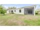 Exterior view of the home and backyard with screened in patio at 1012 Bradford Ridge Dr, Leesburg, FL 34748