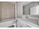 Well-lit bathroom with a shower-tub combo and a white vanity with a modern faucet and granite countertops at 1012 Bradford Ridge Dr, Leesburg, FL 34748