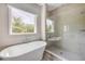 Beautiful primary bath featuring a soaking tub, walk-in shower, and a large window at 1012 Bradford Ridge Dr, Leesburg, FL 34748