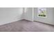 A secondary bedroom featuring natural light and neutral colored carpet and paint at 1012 Bradford Ridge Dr, Leesburg, FL 34748